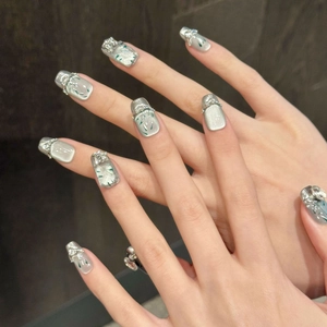 Silver cat eye press-on nails with green bamboo leaf motifs and 3D rhinestone accents