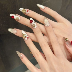 Cat eye press-on nails with 3D heart rhinestones and gold stars on long almond shape