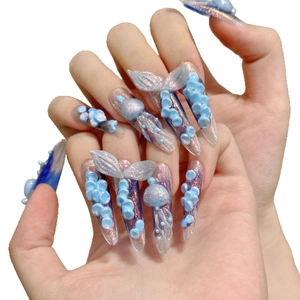 3D ocean-themed press-on nails with fishtail and jellyfish designs on stiletto tips