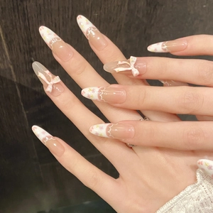 Floral French press-on nails with pink 3D bows and white hand-painted almond shape tips