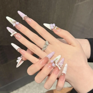 Handmade stiletto press-on nails featuring 3D lavender tulips and elegant bow designs