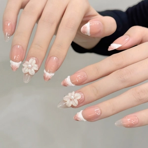 French tip press-on nails with 3D white flowers and pearls on nude base almond shape