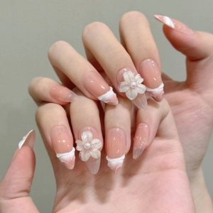Pink gradient almond press-on nails with 3D white flowers and pearl accents