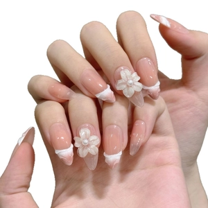 Pink gradient French press-on nails with 3D floral accents and pearl details