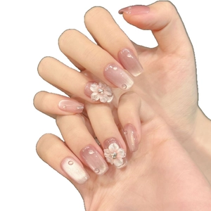 Pink cat eye press-on nails with 3D white flowers and gradient glitter design