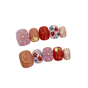 Japanese style handmade press-on nails with 3D floral art, gold foil, and red flower designs