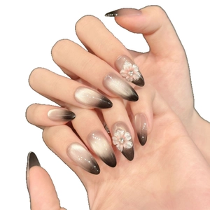 Black cat eye gradient press-on nails with 3D white flower petals and long almond shape