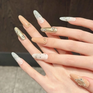 Detailed view of handmade press-on nails with 3D butterfly charms and gradient sequins