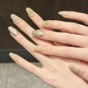 Handmade press-on nails with 3D floral designs, gold foil, and dried flower accents