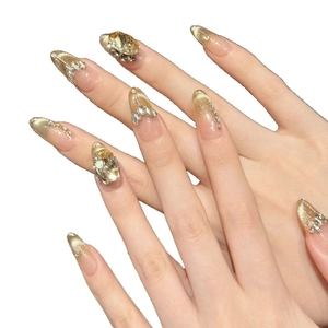 Luxury gold cat eye press-on nails with large oval rhinestones and diamond accents