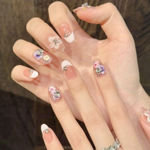 French style press-on nails with 3D floral carvings and rhinestones on wood background