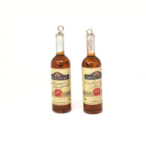 Detail of resin red wine bottle earrings featuring realistic Cabernet Sauvignon labels