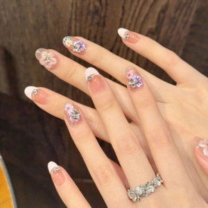 French 3D floral press-on nails with nude pink base and sparkling rhinestone details
