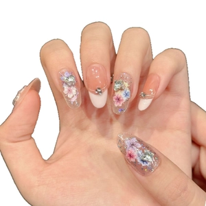Floral French press-on nails with dried flowers, rhinestones, and glitter finish