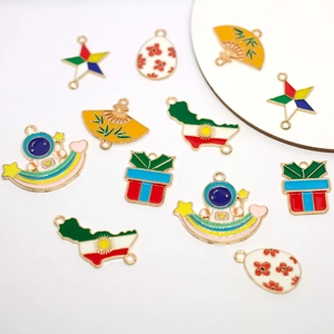 Assorted DIY enamel charms with rainbow, astronaut, and map designs in gold alloy