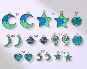 Macro detail of nine blue starry sky alloy charms with crescent moon and planet motifs
