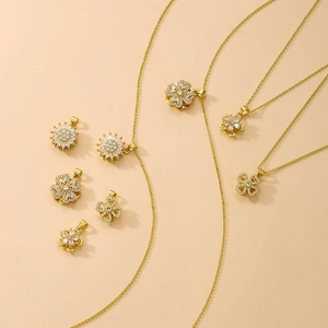 Detail of rotating four-leaf clover pendant with sparkling AAA zircons and 18K gold plating