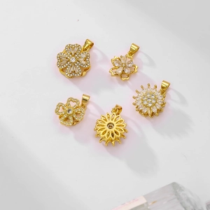 Rotating gold-plated clover and flower pendants with sparkling cubic zirconia stones