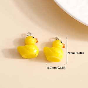 Cute yellow resin duck charms for DIY jewelry with dimensions 20mm by 15.7mm