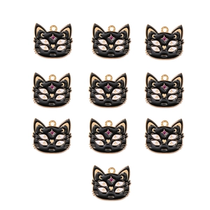 Detail of 10 enamel black cat tarot charms with four eyes and star gem on white background