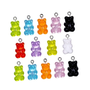 Macro shot of colorful translucent resin gummy bear charms with silver metal eyelet hooks