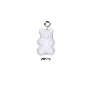 Macro shot of a translucent white gummy bear resin pendant with a silver metal hook