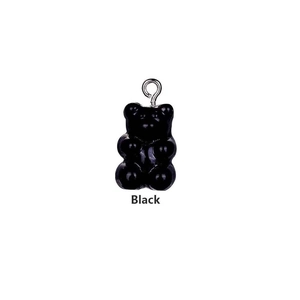 Macro shot of a black resin gummy bear pendant with a polished finish and silver ring