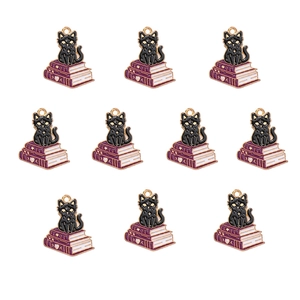 Detailed view of 10 purple book and black cat enamel charms for DIY jewelry making