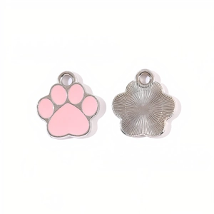 Macro detail of alloy cat paw pendants with pink enamel front and sunburst texture back