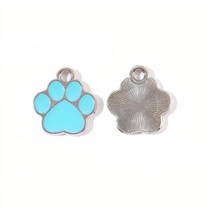 Macro view of light blue paw-shaped alloy pendant showing both front and back details