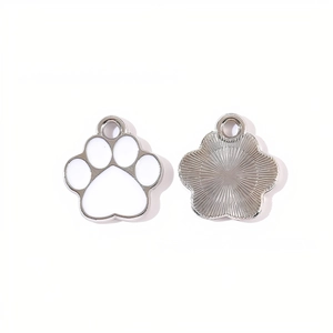 Detail of silver alloy cat paw pendant with white enamel and radial metal texture back