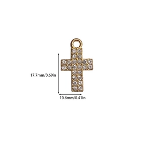 Macro shot of gold-plated cross pendant with white zircon pavé and size measurements