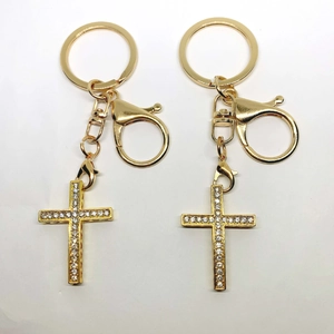 Pair of gold alloy cross keychains with sparkling cubic zirconia crystals for bags