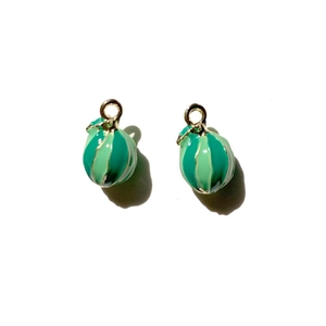 Macro detail of pair of 3D miniature watermelon charms with striped green enamel and gold ring