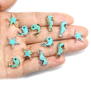 Marine dolphin and seahorse charms set with turquoise stones and gold finish