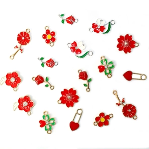 Detailed flat lay of red and white enamel flower charms and heart pendants for DIY jewelry