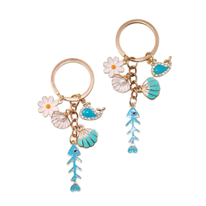 Golden ocean keychain with shell, starfish and whale charms in blue and pink enamel