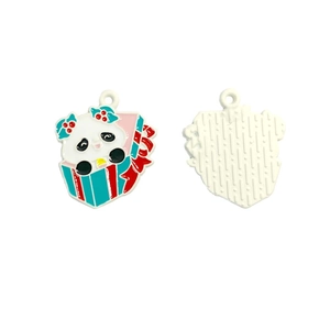 Close-up of enamel panda charm in gift box with festive holly and textured metal back