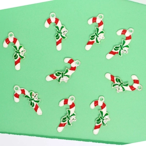 Detailed view of ten red and white candy cane pendants with green bows and small rhinestones