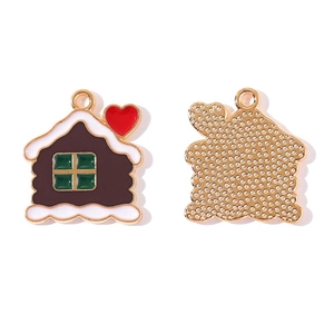 Detail of gingerbread house pendant with enamel coating and textured golden backside