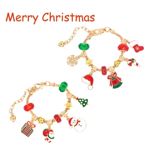 Detail view of Christmas charm bracelets with Santa and snowman pendants in red and gold