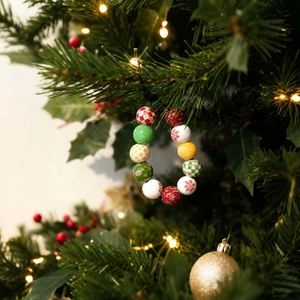 Close-up of festive 16mm Christmas wooden beads with snowflake and tree patterns