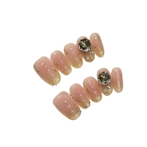 Champagne rose press-on nails with nude gradient, gold glitter and smoky zircon accents