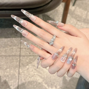 Cat eye stiletto press-on nails with 3D floral relief and rhinestone chains