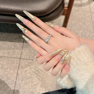 Luxurious champagne gold cat-eye press-on nails with 3D rhinestones and pearl accents