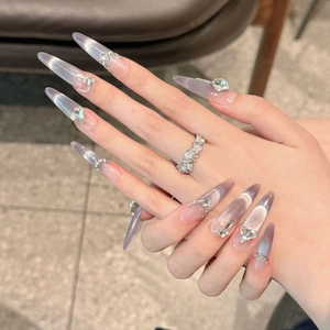 Long almond press-on nails with purple cat eye gradient and silver rhinestone accents
