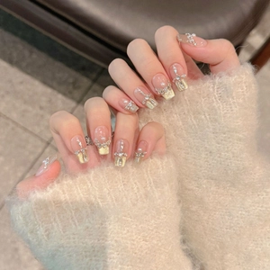 Handmade cat eye press-on nails with pearls, crystals, and gold glitter in square shape