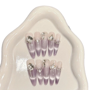 Purple cat eye press-on nails with luxury rhinestones and silver cross charms