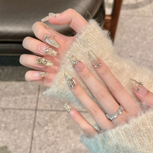 Cat eye press-on nails in champagne gold with rhinestone accents and square crystals