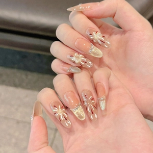 Long stiletto cat-eye press-on nails with fireworks design and gold glitter accents
